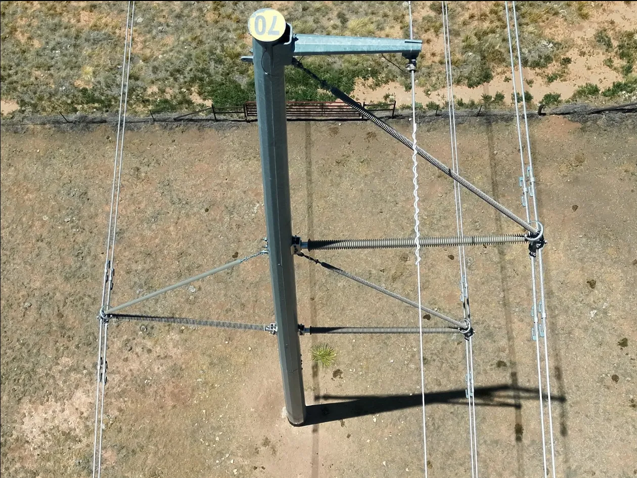 Overhead drone view of an H-frame transmission structure and crossarm